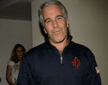 a man wearing a monogrammed sweatshirt with the letters jfg