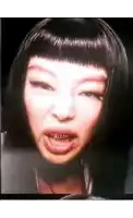 a close up of a woman making a funny face with her mouth open .