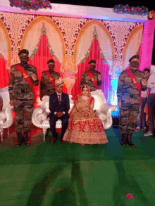 a bride and groom are posing for a photo with soldiers standing behind them