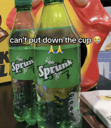 two bottles of sprite with the caption can t put down the cup