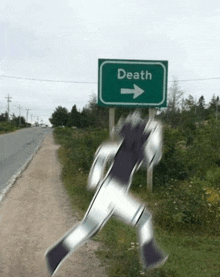 a green road sign that says death on it