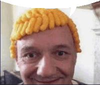 a man wearing a yellow wig is smiling and looking at the camera .