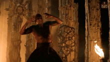 a man is standing in front of a wall with the words " the bone temple " on the bottom right