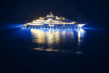 a large yacht is floating in the ocean at night