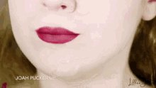 a close up of a woman 's lips with a red lipstick .