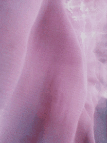 a close up of a pink cloth with a purple texture