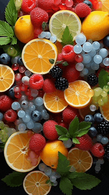 a variety of fruits and berries including oranges raspberries blueberries and blackberries