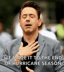 a man in a suit holds his hand to his chest with the words " we made it to the end of hurricane season " below him