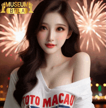 a woman in a toto macau shirt is standing in front of fireworks