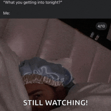 a picture of a person laying in bed with the caption still watching