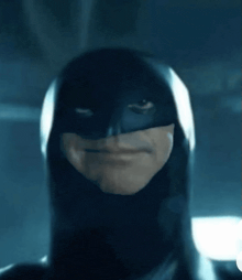 a close up of a man wearing a batman costume