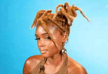 a woman with dreadlocks and earrings is smiling