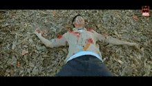 a man is laying on the ground with blood coming out of his face