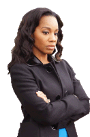 a woman in a black coat with her arms crossed looks serious