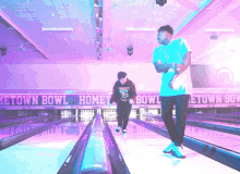 two men are playing bowling at the metown bowl home