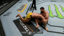 two men are wrestling in a ufc ring sponsored by monster energy drink