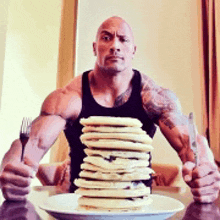 a man is holding a knife and fork in front of a stack of pancakes