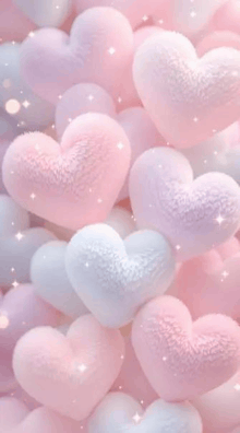 a bunch of pink and white hearts stacked on top of each other .