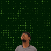 a man stands in front of a green background with the number 10 on it