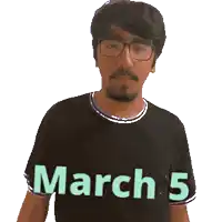 a man wearing glasses and a black shirt with march 5 on it