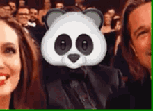 a man and a woman are taking a selfie with a panda mask on their face .