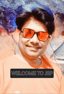 a man wearing sunglasses and an orange shirt with the words welcome to jsp on the bottom