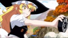 a girl with blonde hair and a black hat is holding a cube