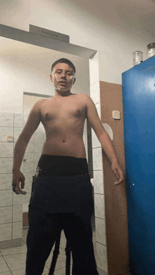 a shirtless man with a bandage on his face stands in front of a door that says ' female ' on it