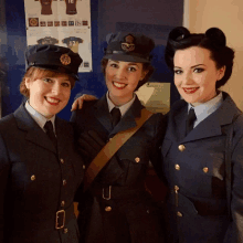 three women are posing for a picture and one has the number 12 on her shirt