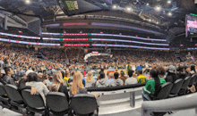 a crowd of people watching a basketball game at the chase center