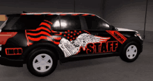 a black and red vehicle with the word staff on the side