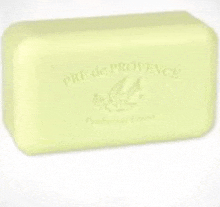 a yellow bar of soap with a bird on it is on a white surface .