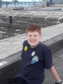 a boy wearing a blue shirt with a badge that says ' florida ' on it smiles