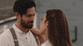 a man and a woman are looking at each other
