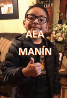 a young boy giving a thumbs up with the name aea manin written above him