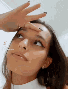 a tiktok video of a woman covering her face with her hands