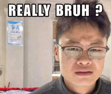 a man wearing glasses is making a funny face with the words `` really bruh ? '' written on his face .