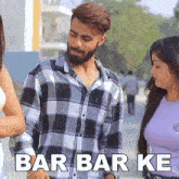 a man in a plaid shirt stands next to a woman with the words bar bar ke written on the bottom