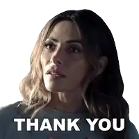 a woman is giving a thank you sign with her hands on her chest