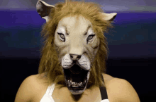 a woman is wearing a lion mask with its mouth open