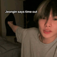 a young man in a white t-shirt says time out