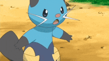 a blue and black cartoon cat is standing on a dirt ground .