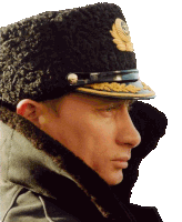 a close up of a man wearing a hat with a gold emblem on it