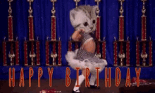 a cat dancing in front of trophies with the words happy birthday