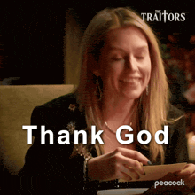 a woman is smiling and holding a piece of paper that says thank god on it