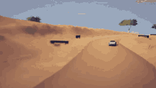 a car is driving down a sandy road in a desert