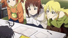 a group of anime girls are sitting around a table with notebooks