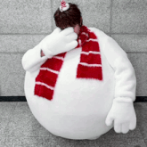 a woman in a snowman costume covering her face