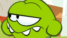 a close up of a green cartoon character 's face
