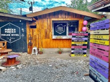 a wooden building with a sign that says puncko puncko tusol bwa